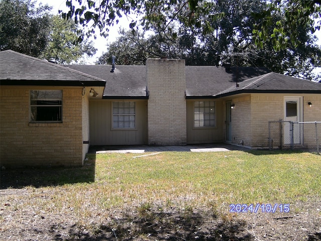 rear view of house with a yard