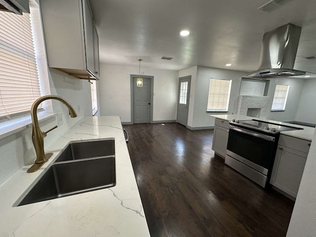 kitchen with gray cabinetry, light stone countertops, extractor fan, and stainless steel electric range