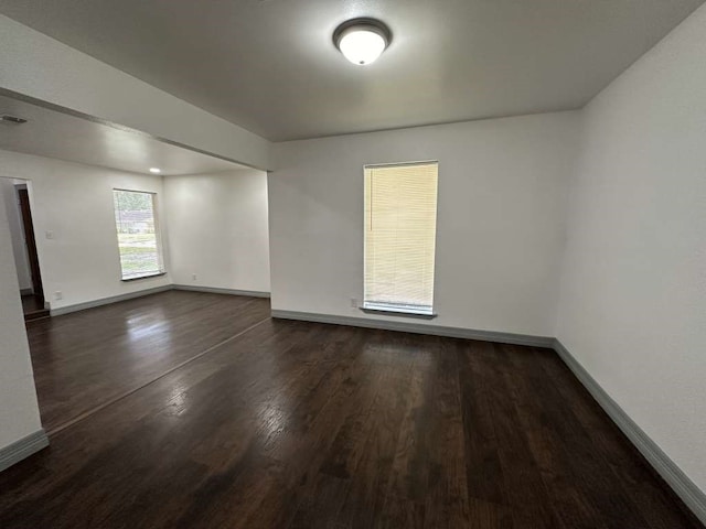 spare room featuring dark wood-type flooring