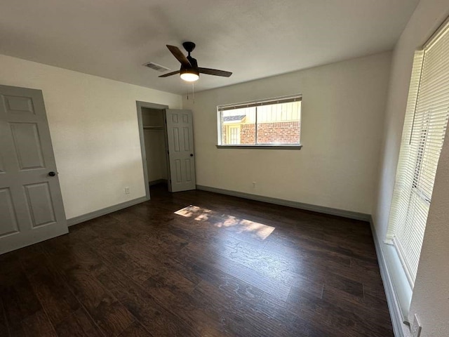 unfurnished bedroom with dark hardwood / wood-style floors and ceiling fan