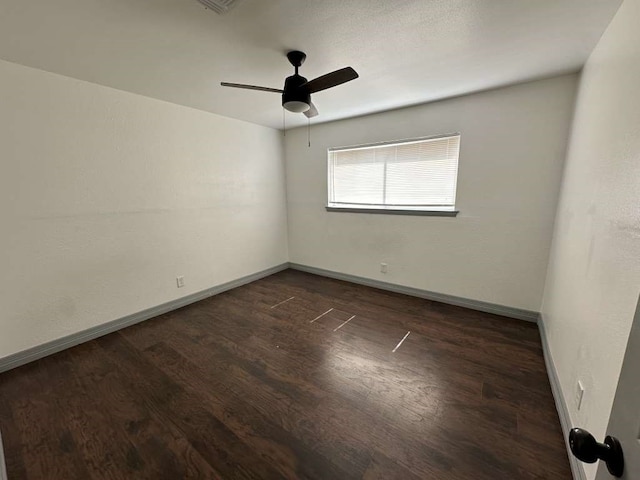 unfurnished room featuring ceiling fan and dark hardwood / wood-style flooring