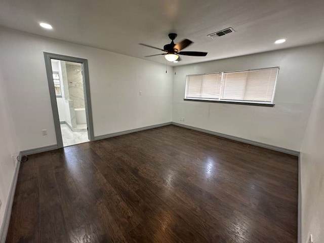 unfurnished room with ceiling fan and dark wood-type flooring