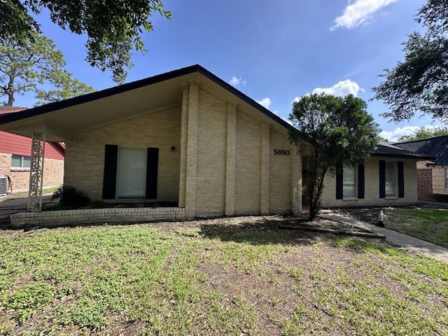 view of property exterior with a yard