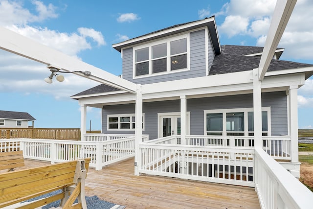 rear view of house featuring a wooden deck