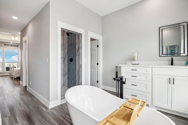 bathroom with vanity, ceiling fan, wood-type flooring, and independent shower and bath