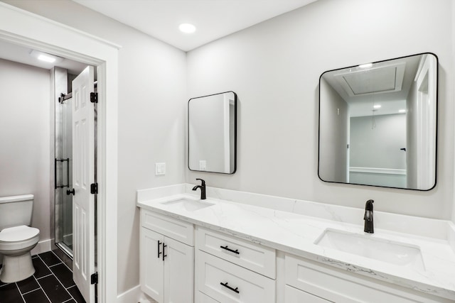 bathroom featuring tile patterned floors, a shower with door, vanity, and toilet