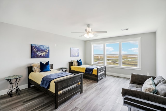 bedroom with ceiling fan and hardwood / wood-style floors