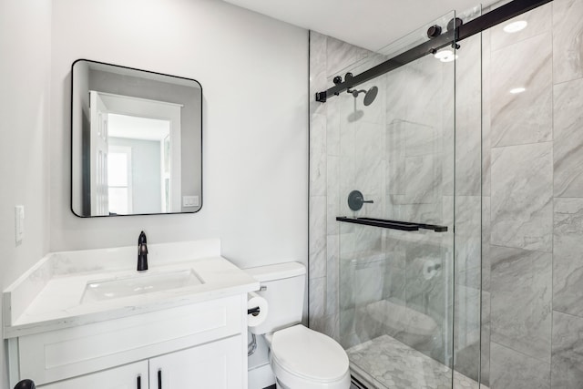 bathroom featuring vanity, an enclosed shower, and toilet