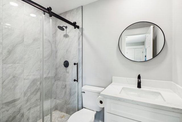 bathroom with vanity, toilet, and a shower with door