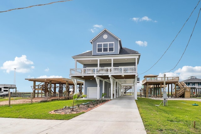555 Pompano Dr Unit Q, Freeport, TX 77541 - raised beach house featuring driveway, a carport, stairs, and a front yard