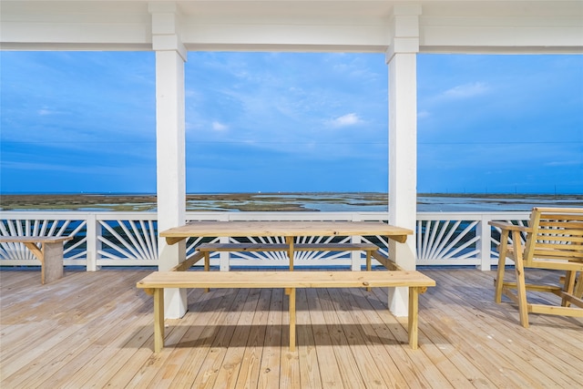 wooden terrace featuring a water view