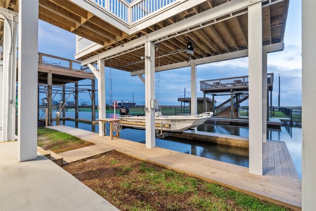555 Pompano Dr Unit Q, Freeport, TX 77541 - dock area featuring boat lift, stairway, and a water view