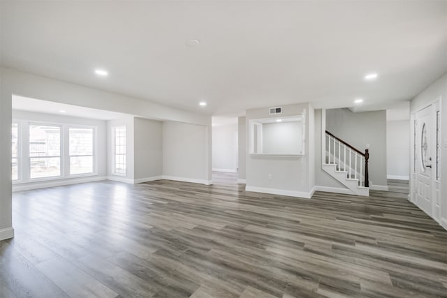 unfurnished living room featuring dark hardwood / wood-style flooring