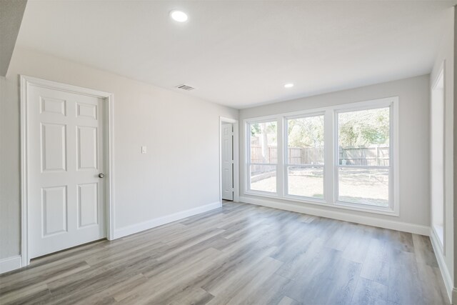 spare room featuring light hardwood / wood-style flooring