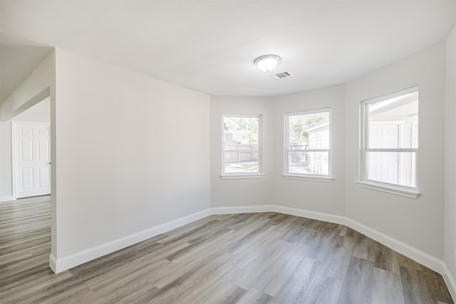 unfurnished room with light wood-type flooring