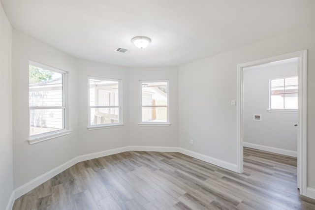 empty room with light hardwood / wood-style flooring