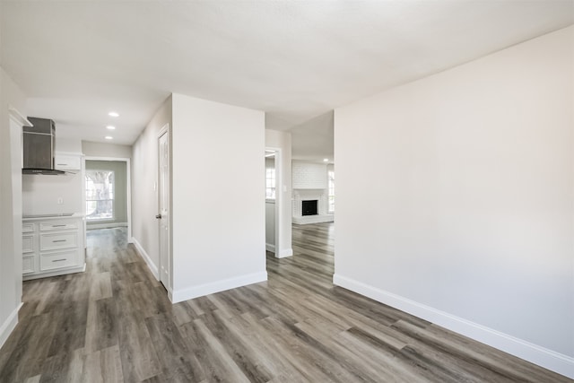 interior space featuring wood-type flooring and a fireplace