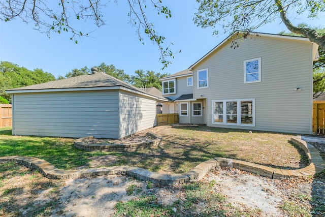 rear view of property featuring a lawn