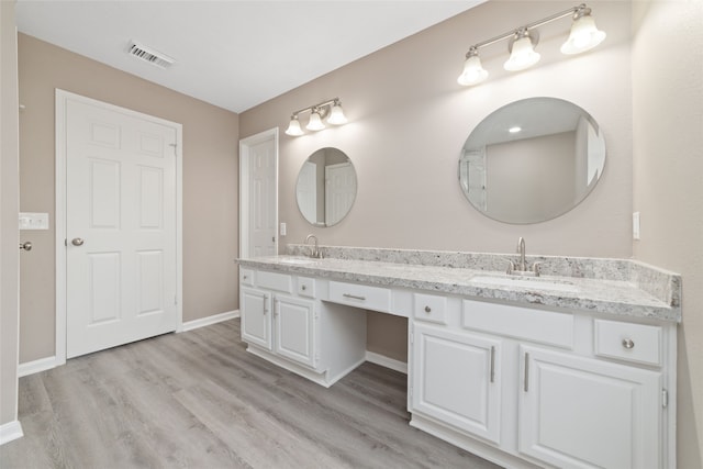 bathroom with vanity and hardwood / wood-style flooring