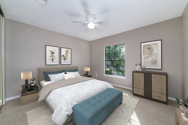 bedroom with light colored carpet and ceiling fan