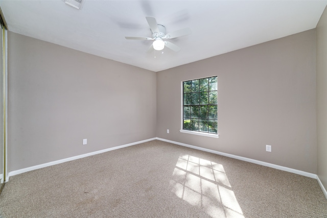 empty room featuring ceiling fan and carpet flooring