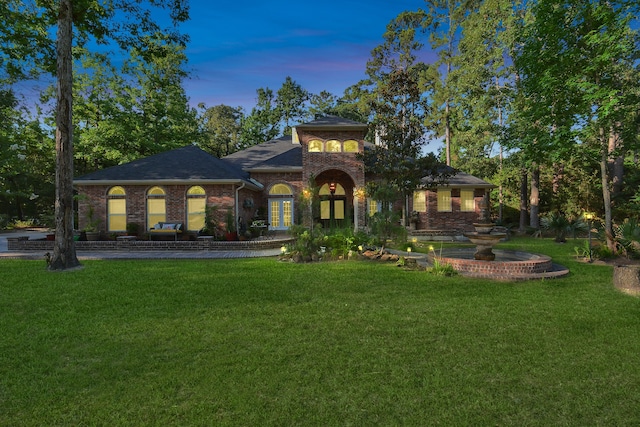 mediterranean / spanish-style home featuring a yard