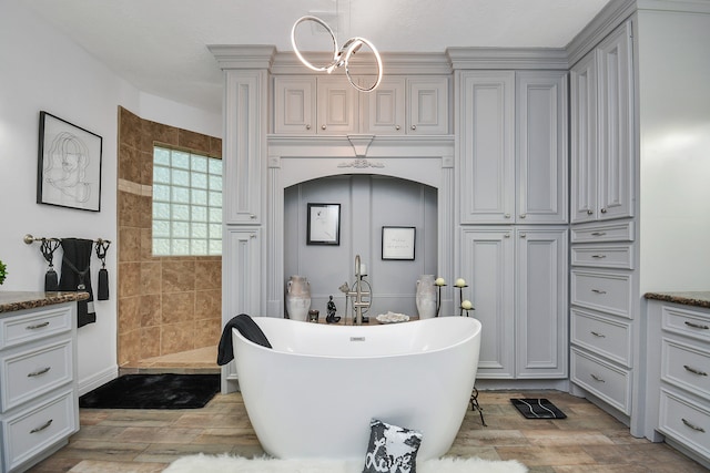 bathroom featuring hardwood / wood-style flooring, a bathing tub, and vanity