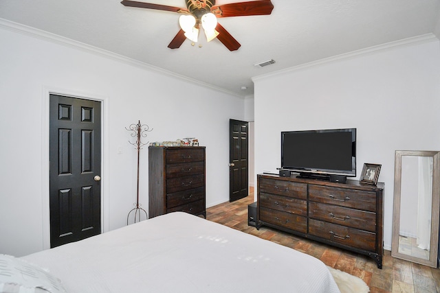 bedroom with ornamental molding, hardwood / wood-style floors, and ceiling fan