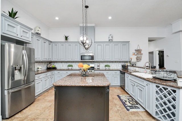 kitchen featuring sink, ornamental molding, kitchen peninsula, hanging light fixtures, and appliances with stainless steel finishes