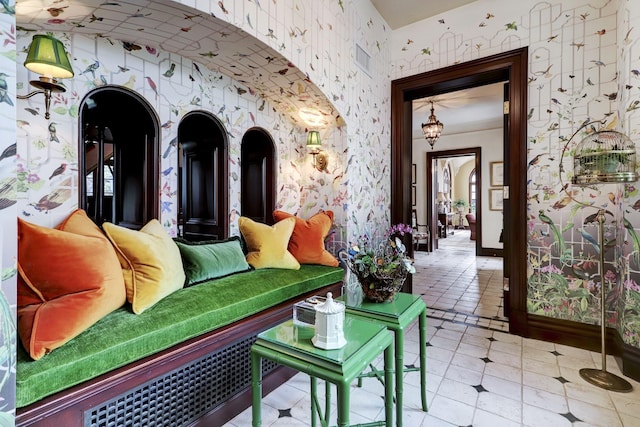 interior space featuring visible vents, wallpapered walls, and baseboards