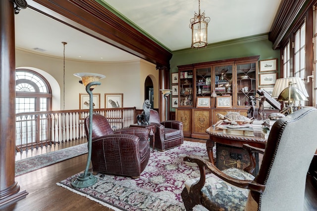 sitting room featuring visible vents, arched walkways, an inviting chandelier, ornamental molding, and wood finished floors
