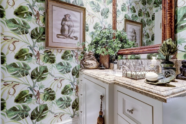 bathroom with wallpapered walls, decorative backsplash, and vanity
