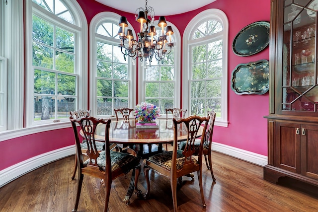 dining area with an inviting chandelier and hardwood / wood-style floors