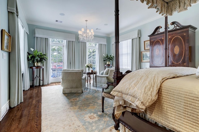 bedroom with a chandelier, visible vents, wood finished floors, and crown molding