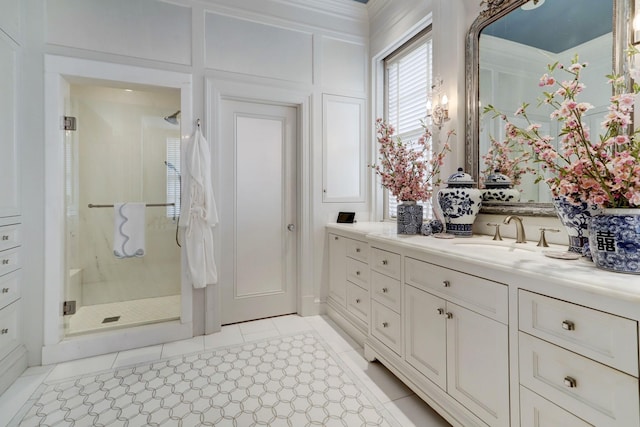 bathroom featuring tile patterned floors, a shower stall, and vanity