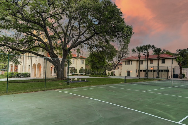 view of sport court with a yard