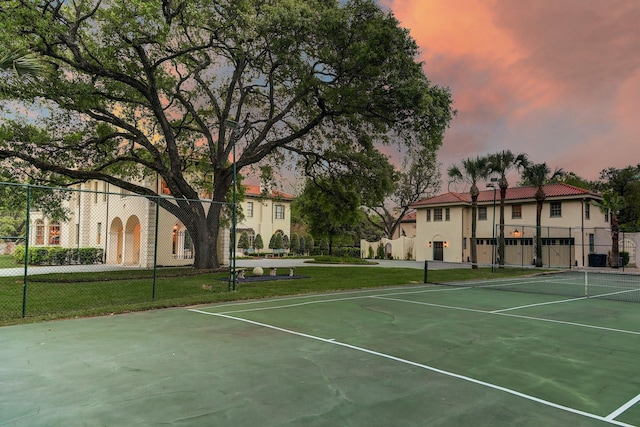 view of sport court featuring a yard and fence