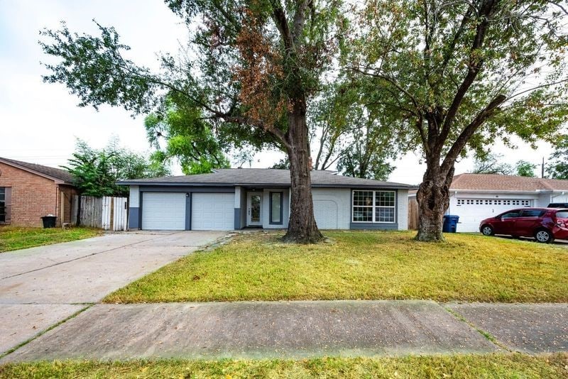 ranch-style home featuring a front yard and a garage