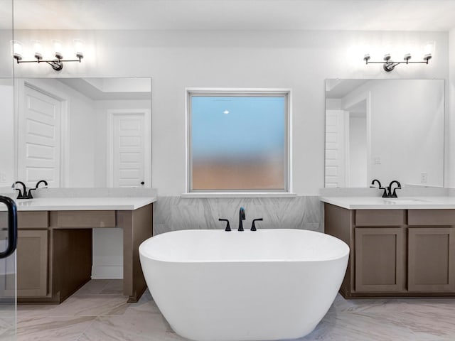 bathroom with a tub and vanity