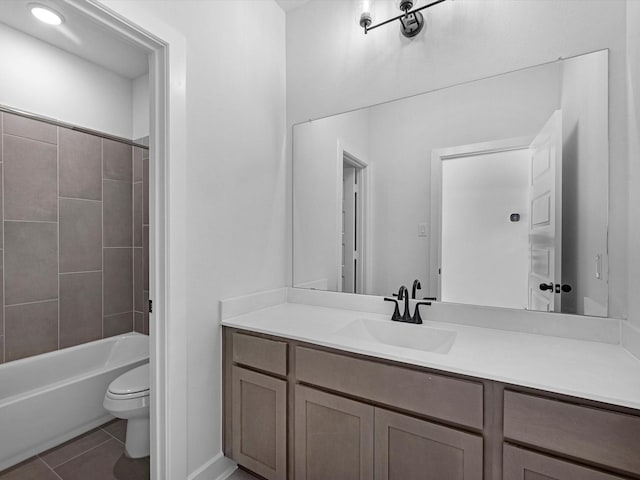 full bathroom featuring tile patterned flooring, vanity, toilet, and tiled shower / bath