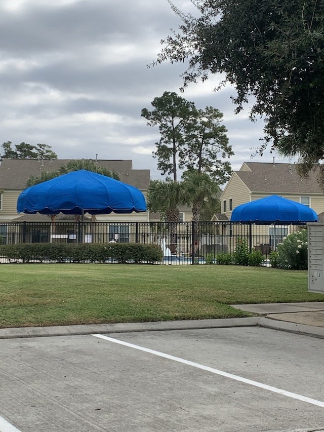 view of vehicle parking featuring a lawn