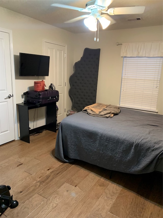 bedroom with ceiling fan and light hardwood / wood-style floors