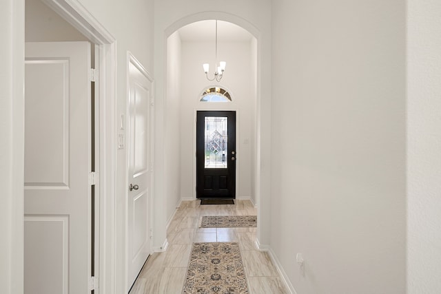 foyer with a chandelier