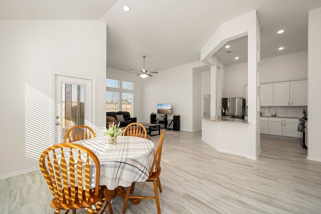 dining room featuring high vaulted ceiling and ceiling fan