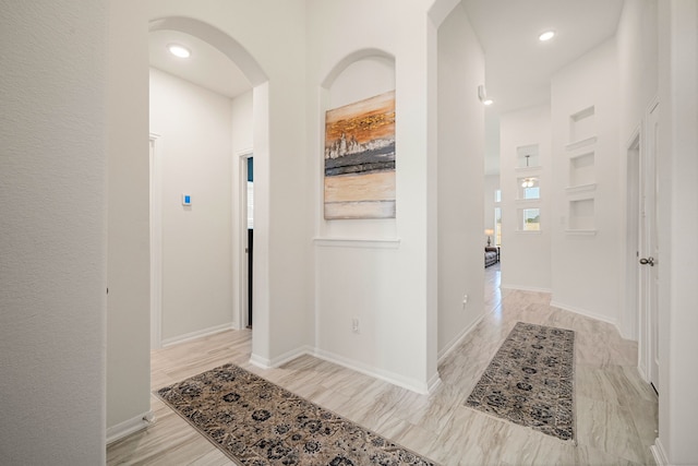 hallway with light hardwood / wood-style flooring