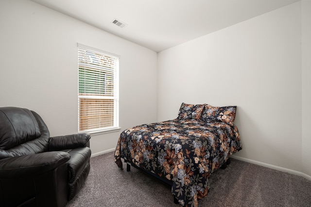 bedroom featuring dark carpet