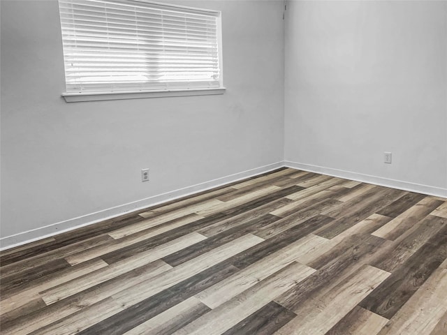 unfurnished room featuring dark hardwood / wood-style flooring