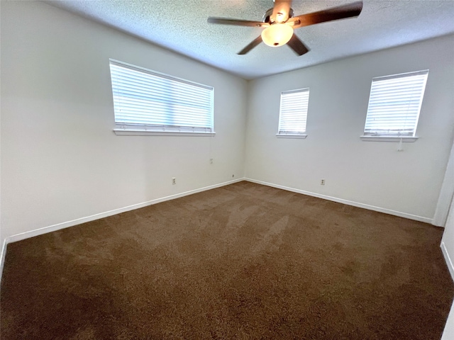 carpeted empty room with ceiling fan and a textured ceiling