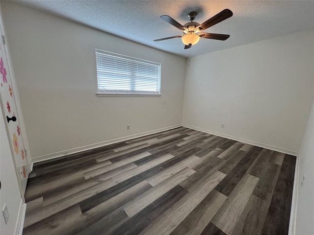 unfurnished room with dark hardwood / wood-style floors, a textured ceiling, and ceiling fan