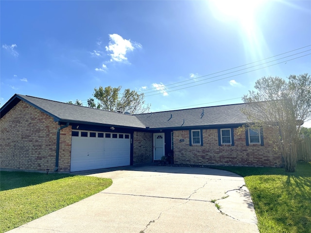 single story home featuring a front yard and a garage